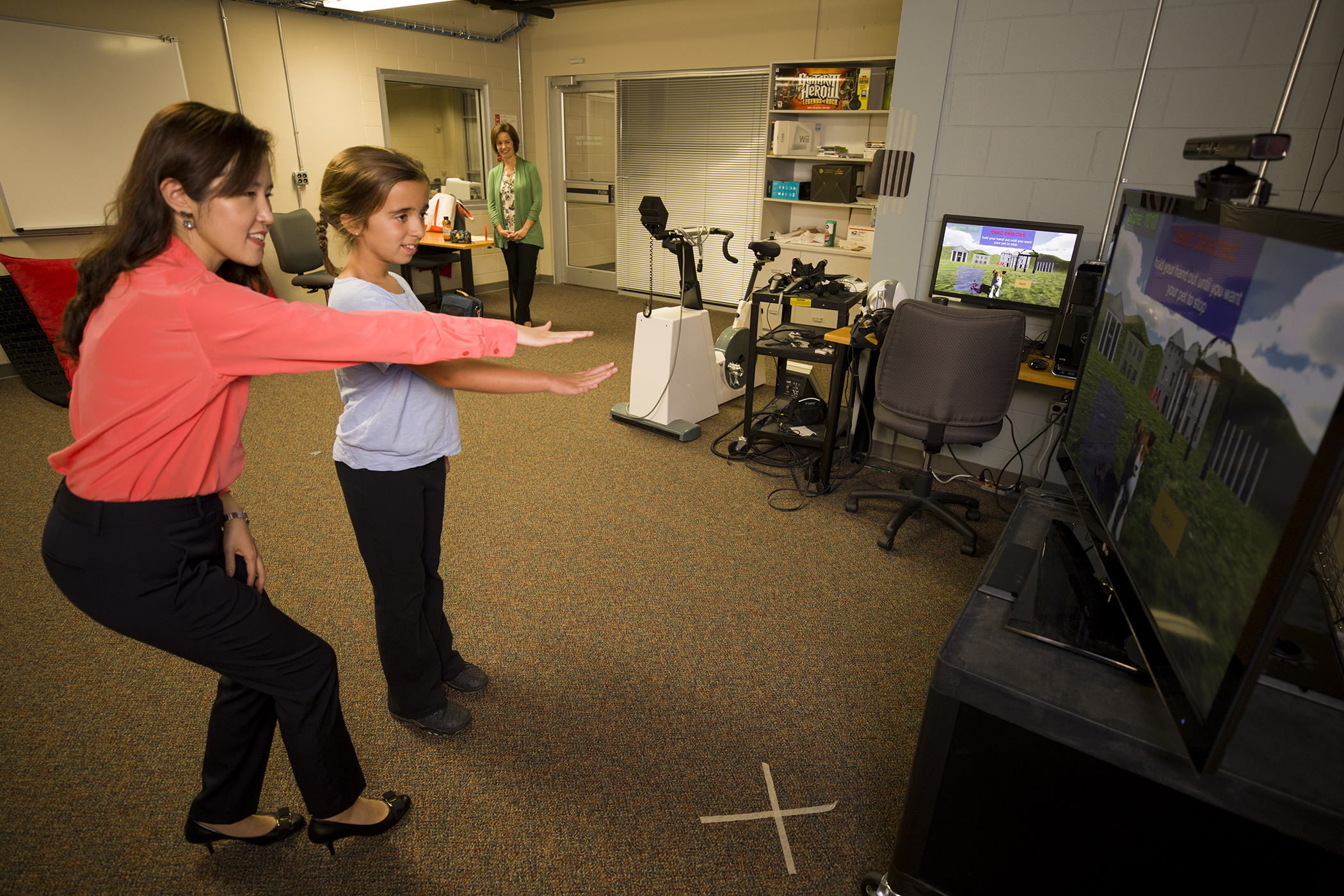 Description: Associate Professor Dr. Sun Joo (Grace) Ahn, left, helps nine year old Maddie Lacey of Watkinsville with interacting with the virtual buddy fitness kiosk in the GAVEL Lab at the Grady College of Journalism.
Date of Photo: 9/1/2017
Credit: Andrew Davis Tucker, University of Georgia
Photographic Services File: 35137-028

The University of Georgia owns the rights to this image or has permission to redistribute this image. Permission to use this image is granted for internal UGA publications and promotions and for a one-time use for news purposes. Separate permission and payment of a fee is required to use any image for any other purpose, including but not limited to, commercial, advertising or illustrative purposes. Unauthorized use of any of these copyrighted photographs is unlawful and may subject the user to civil and criminal penalties. Possession of this image signifies agreement to all the terms described above.